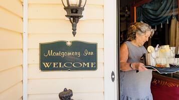 A sign reading "Montgomery Inn Welcome" on a building's exterior wall.