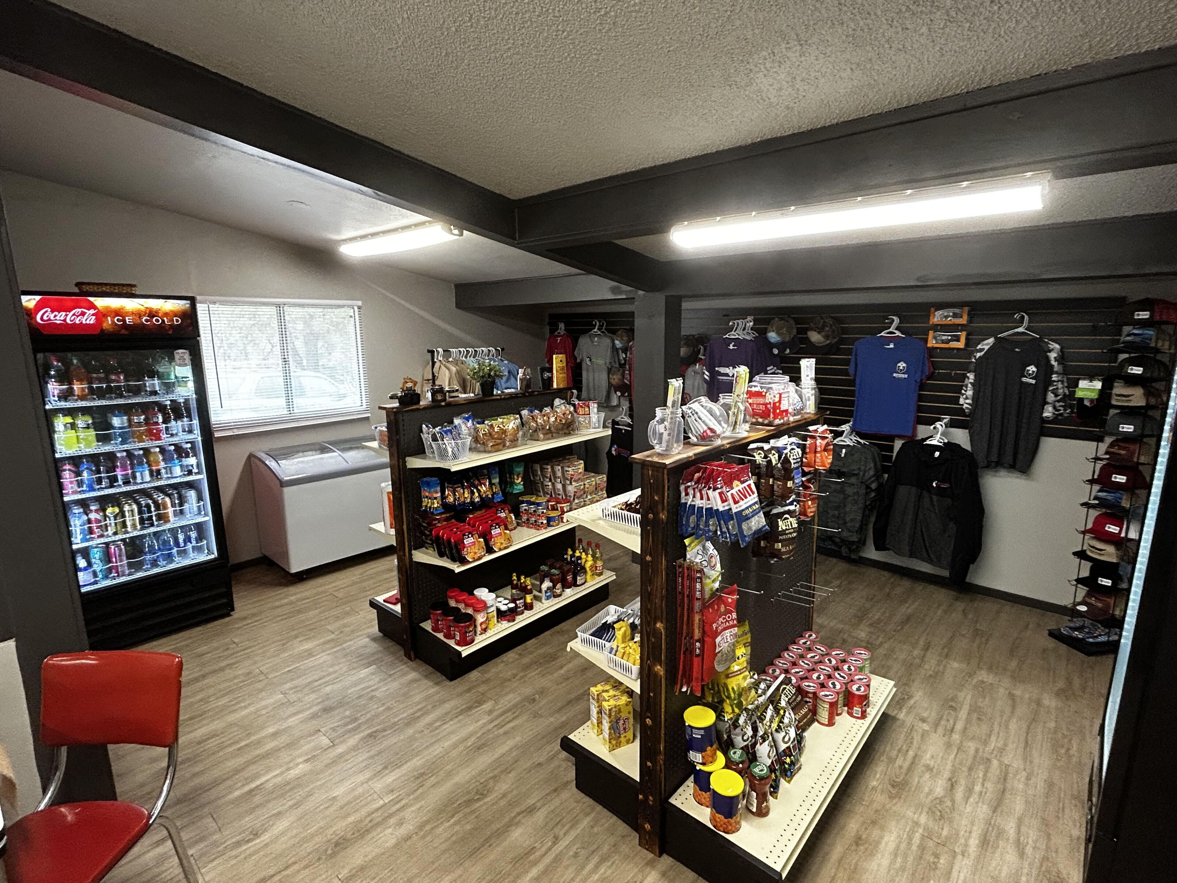 A convenience store with shelves stocked with snacks, beverages, and household items.