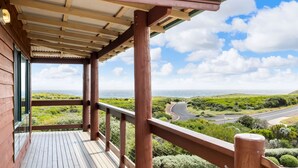 A wooden balcony with a view of a coastal landscape and a road. - Red Door - **Spectacular views, close to beach, large spaces** (Gnarabup)