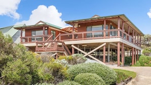 A two-story wooden house with a balcony, surrounded by dense shrubbery. - Red Door - **Spectacular views, close to beach, large spaces** (Gnarabup)