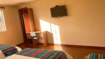 Une chambre avec deux lits, un bureau et une chaise.