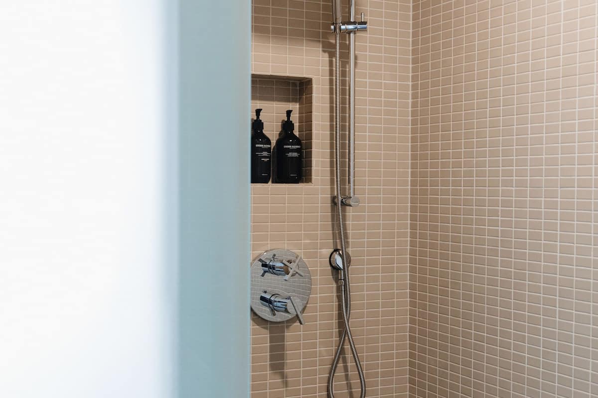 signature double room, 2 queen beds | bathroom | shower, rainfall showerhead, designer toiletries, hair dryer