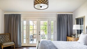 A bedroom with a bed, a chair, a nightstand, a lamp, and a mirror. - Kierland Retreat w/Heated Pool & Outdoor Fireplace  (Scottsdale)