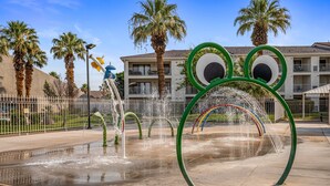 A water fountain with a frog design, palm trees, and a building in the background. - Las Palmas Resort 1805, Resort Access in St George (St. George)