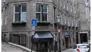A historic building with a corner entrance, a sign indicating the CITI Hotel is now open, and a Cafe Royal sign below. - Citi Hotel Aberdeen City Centre (Aberdeen)
