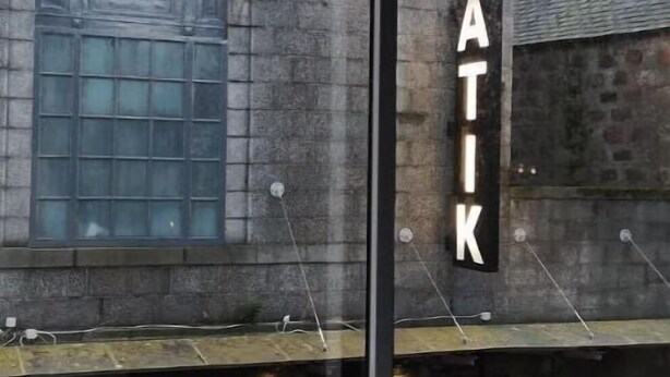 A building with a large glass window and a sign that reads "ATIK". - Citi Hotel Aberdeen City Centre (Aberdeen)