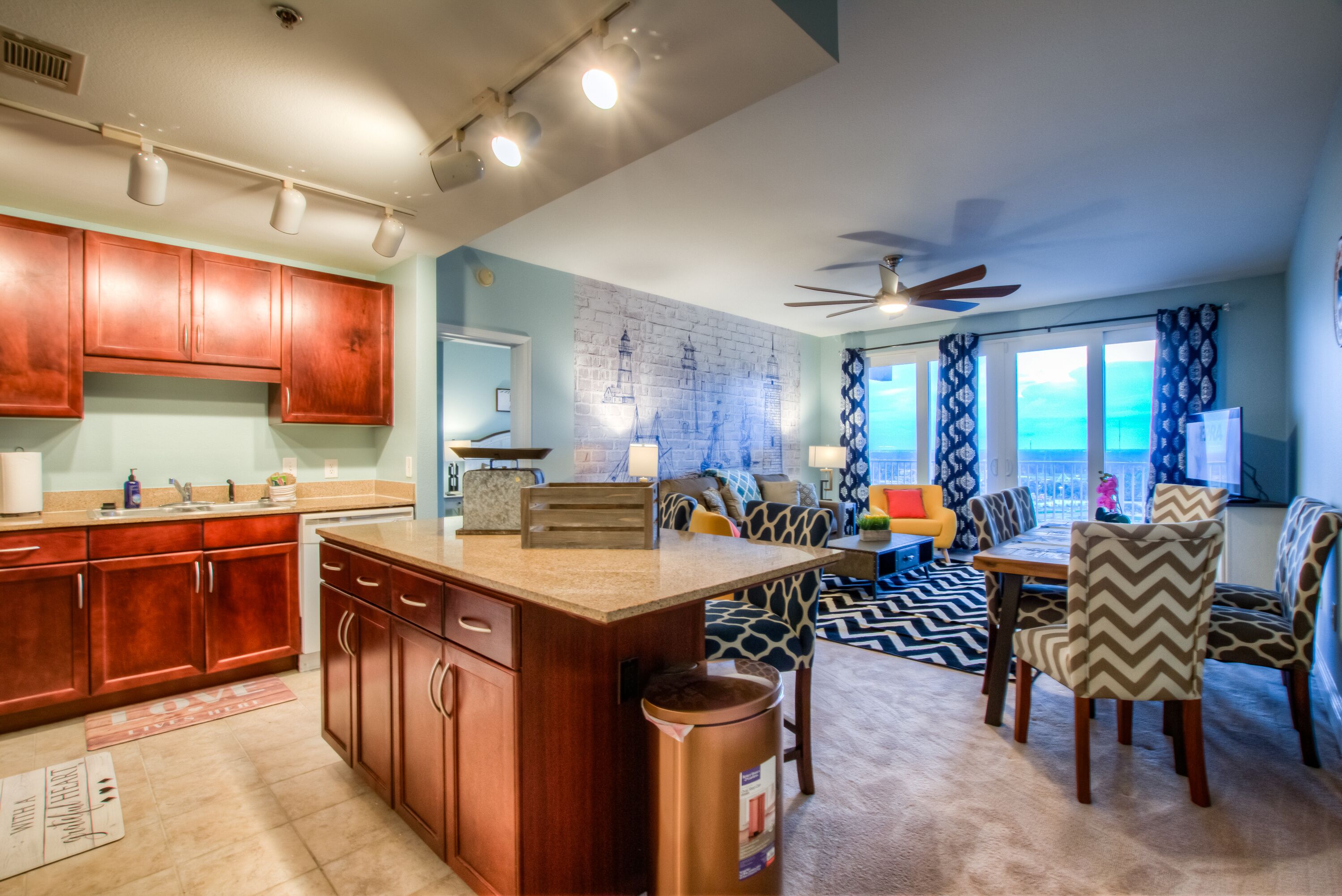 A spacious living area with a kitchen, dining table, and seating.