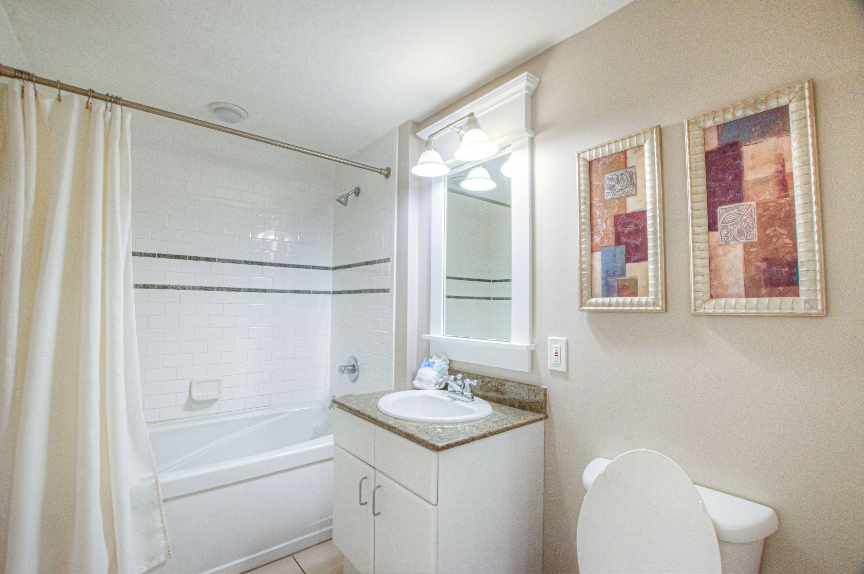 A bathroom with a bathtub, sink, and toilet.