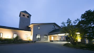 A large building with a prominent tower and multiple windows, likely a hotel or institutional building.