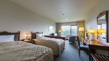 A hotel room with two beds, a desk, a chair, a lamp, and a large window.