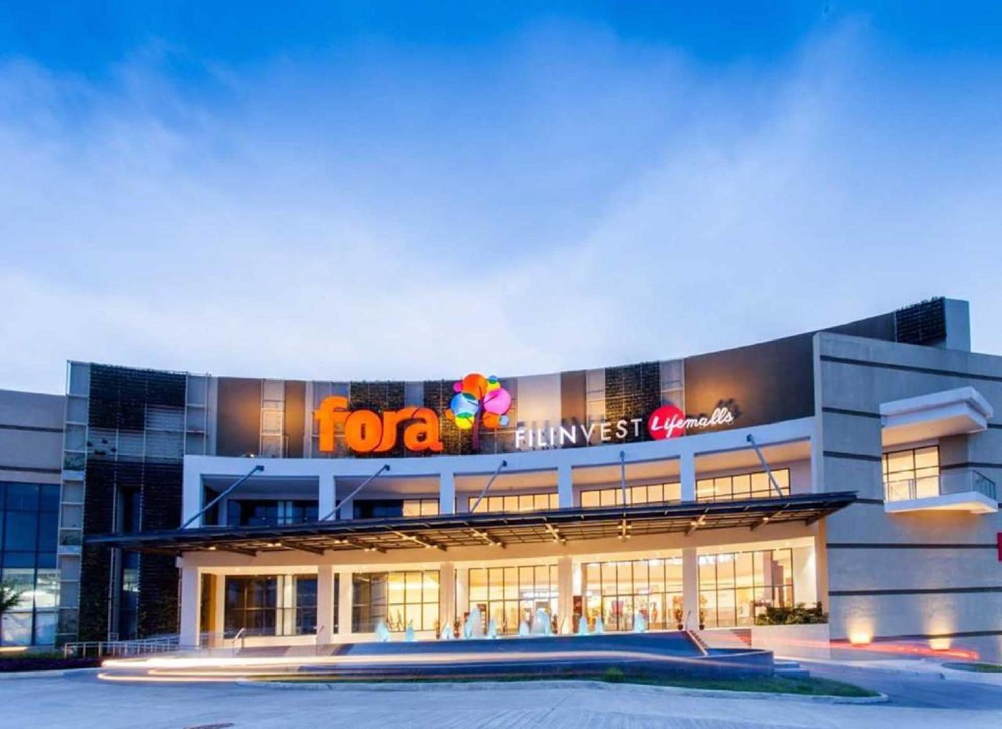 A modern building with a prominent 'fora' sign and 'FILIN VEST' branding.