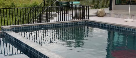Outdoor pool, open 7 AM to 10 PM, pool umbrellas, pool loungers