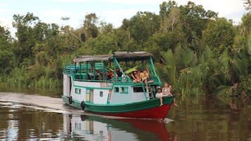 Explore the tranquil waters surrounded by lush greenery on this passenger boat.