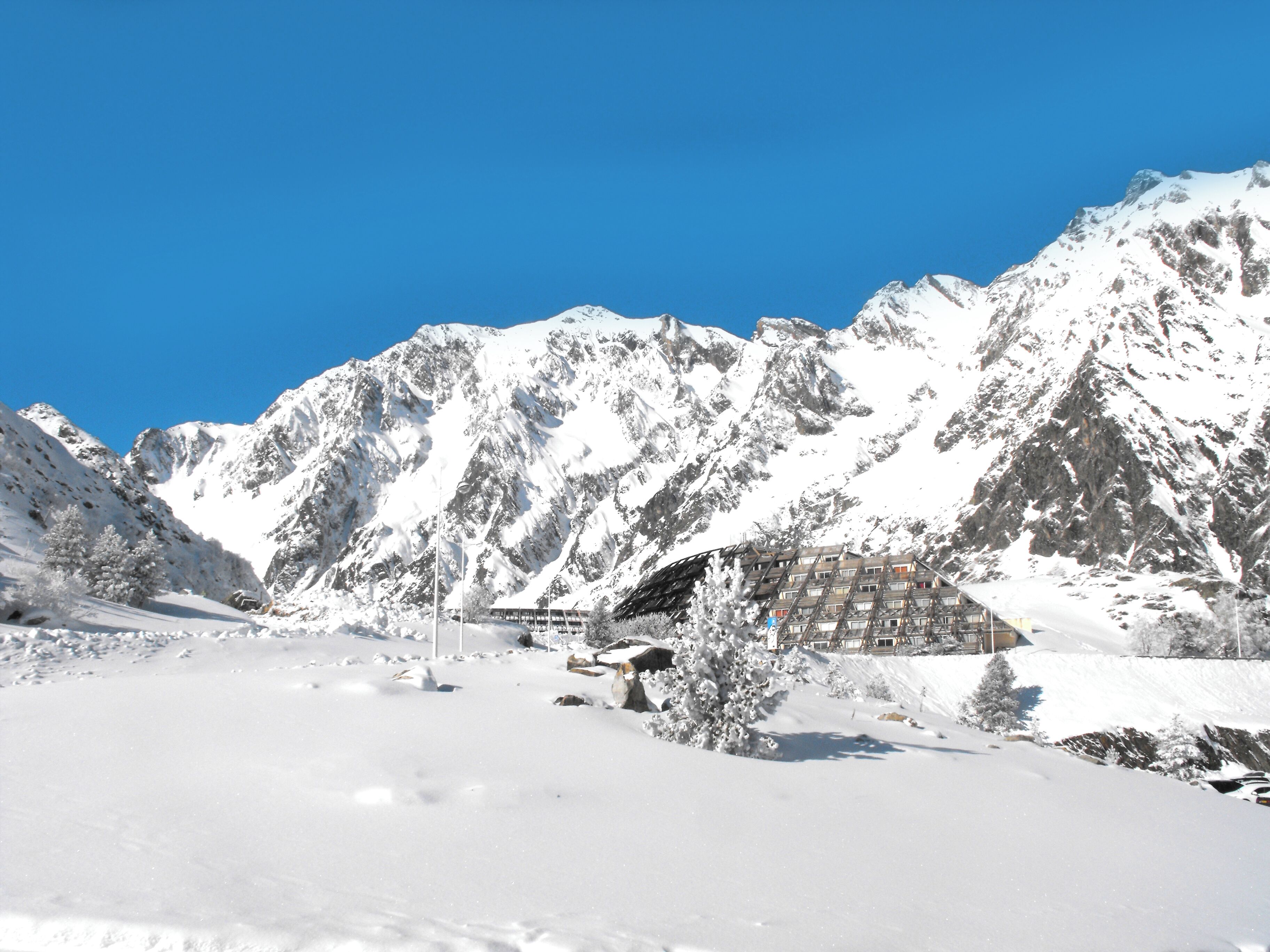A snow-covered mountain landscape with a building featuring a modern architectural design.