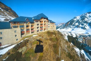 A multi-story hotel with balconies, set against a mountainous backdrop. - Azureva La Mongie (Bagnères-de-Bigorre)