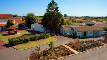 A residential area with houses, a gazebo, and a well-maintained garden.