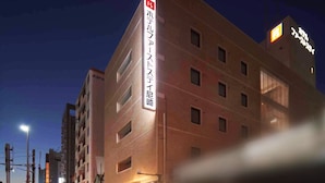 A multi-story hotel with a prominent sign indicating it is a hotel. - Hotel First Stay Amagasaki (Amagasaki)