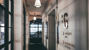 En korridor med en skylt som visar vägen till receptionen och parkeringen.