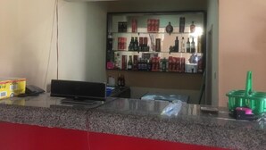 A bar area with shelves stocked with various liquor bottles and boxes. - Villa Savoye Hotels and Resorts (Lekki)