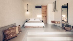 Une chambre moderne avec un grand lit, une tête de lit en bois, une table de chevet, un miroir et un luminaire suspendu.