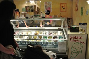 A gelato shop with a display case of various gelato flavors.