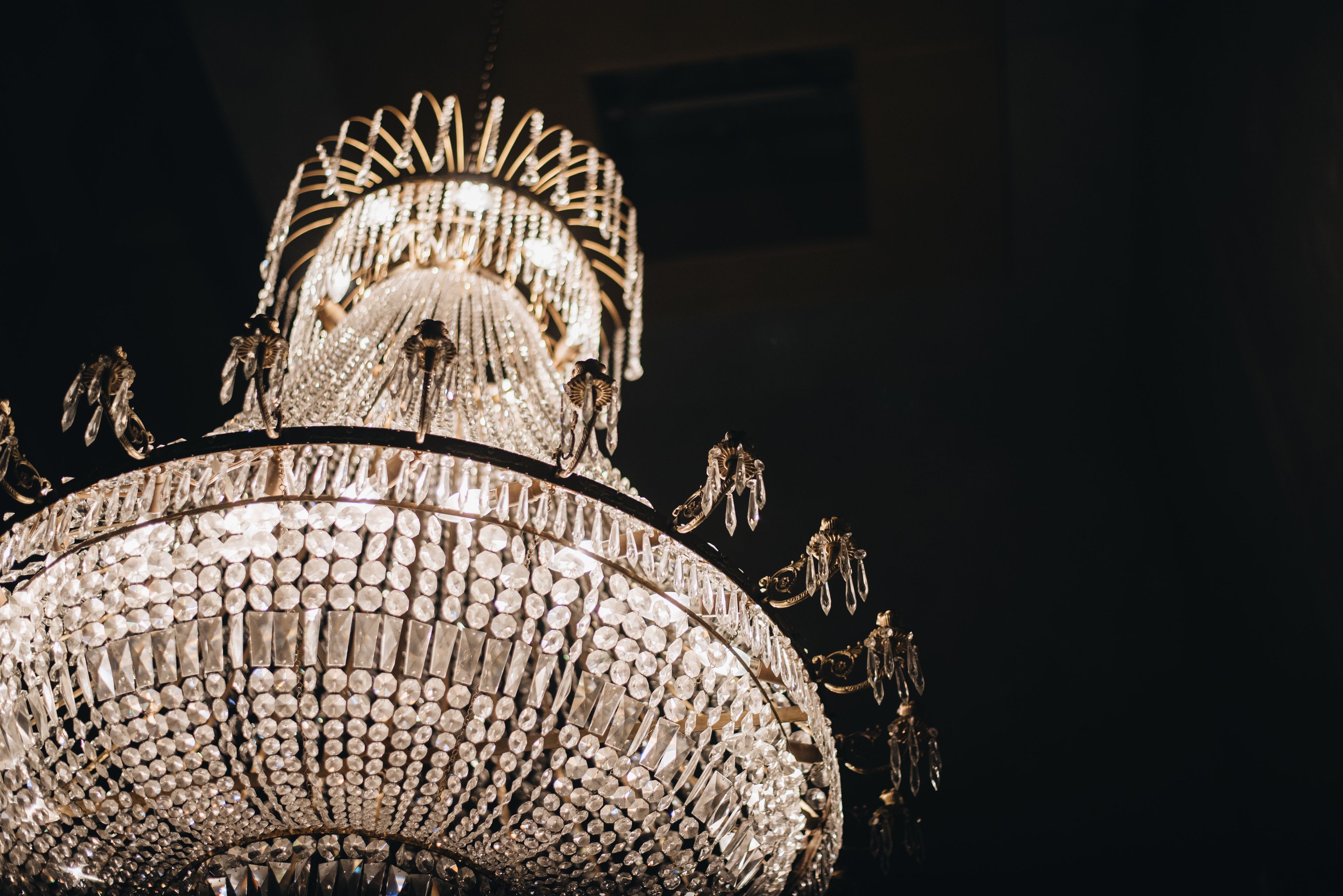 A large, ornate chandelier with multiple tiers and crystal decorations.