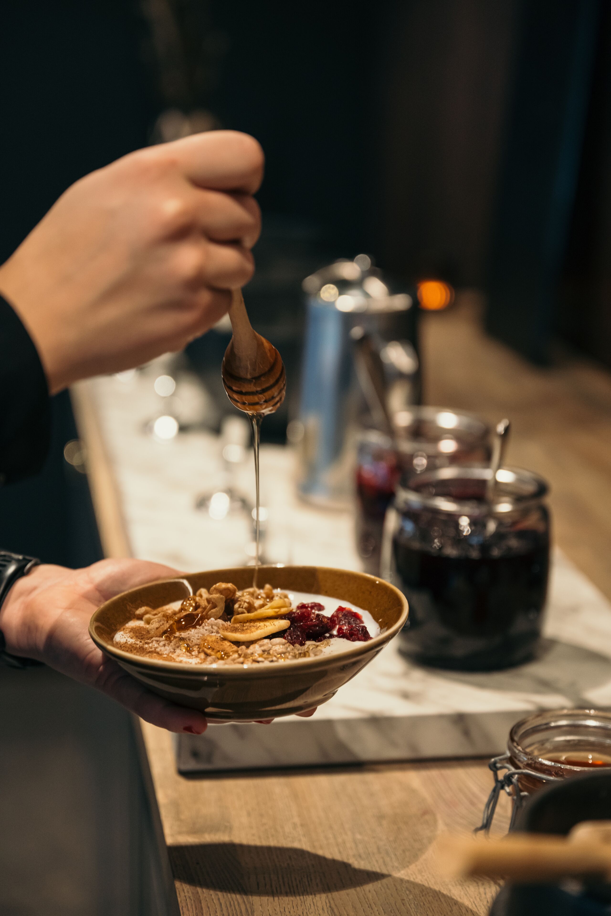 A person holding a bowl of cereal with a spoon.
