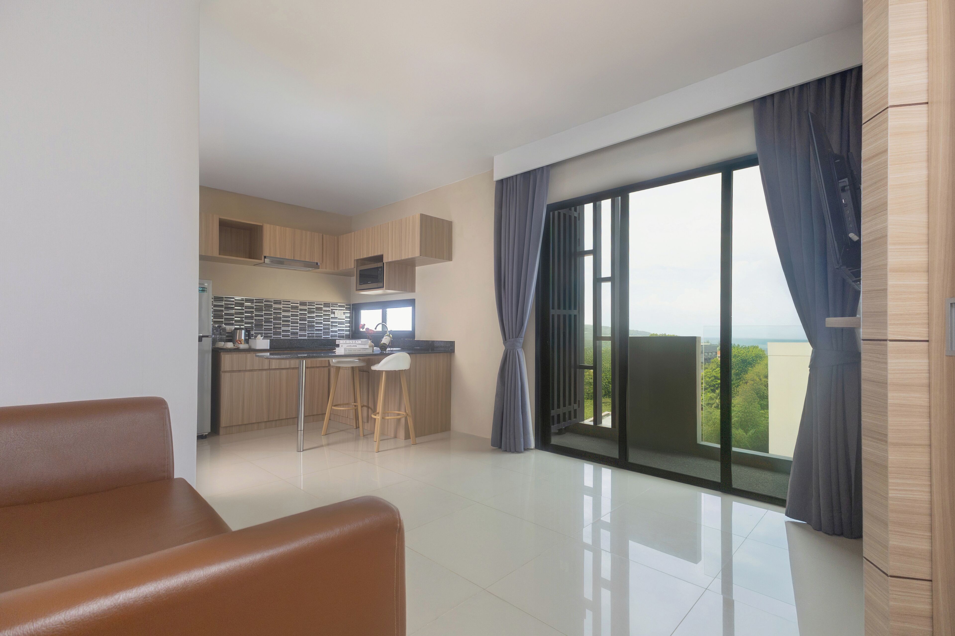 A modern apartment with a kitchen, dining area, and a balcony with a city view.