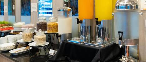 A buffet area with various food items and beverages.
