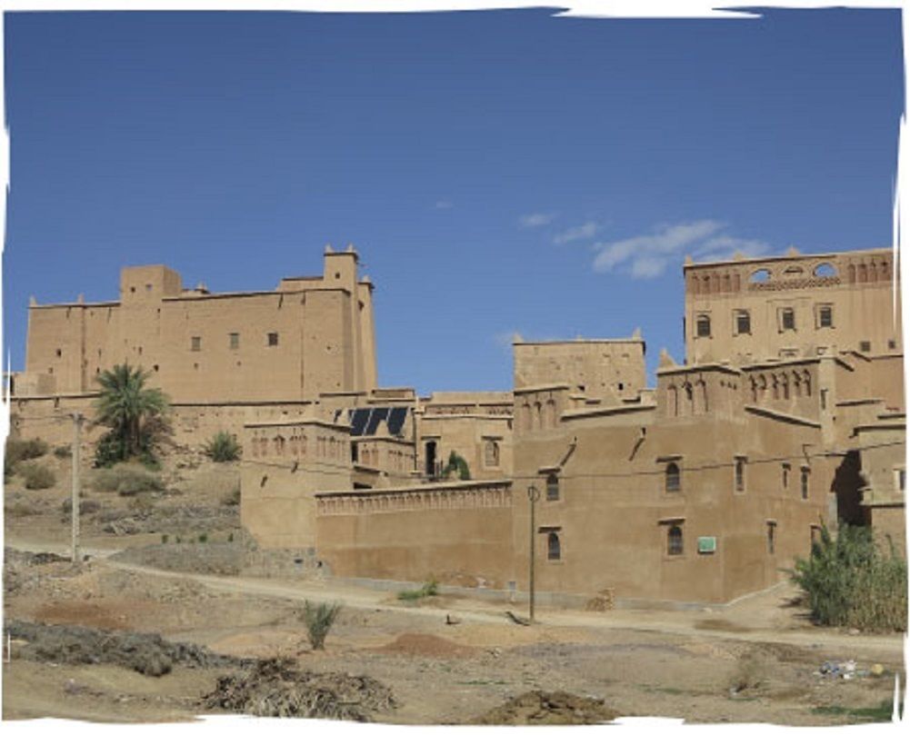 A large, historic building with multiple levels and a prominent tower.