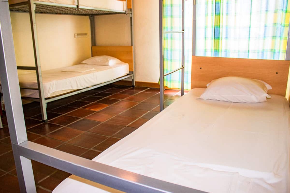 Ein Schlafsaalzimmer mit Etagenbetten und einem Einzelbett.