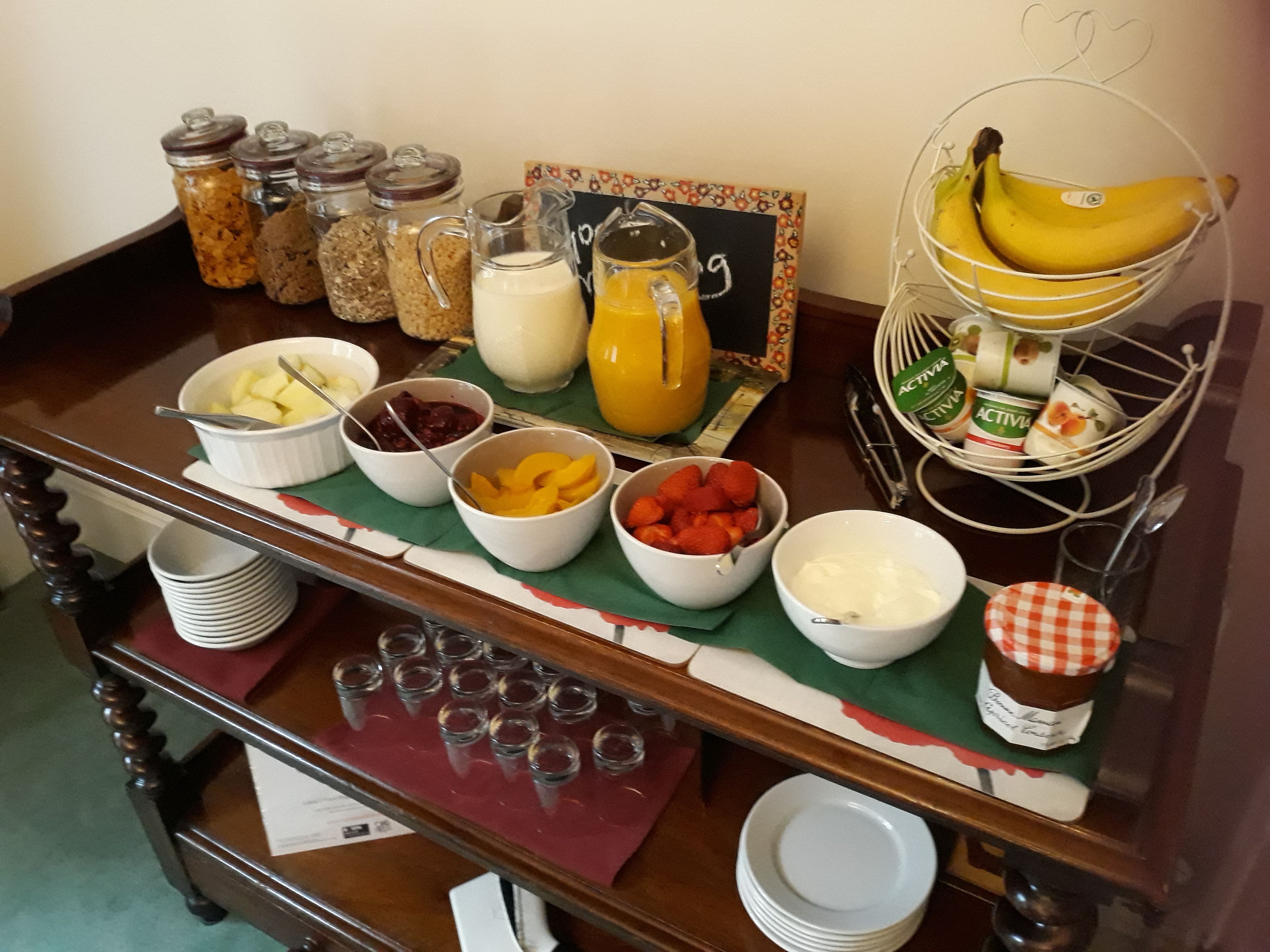 A breakfast buffet with various food items and beverages.