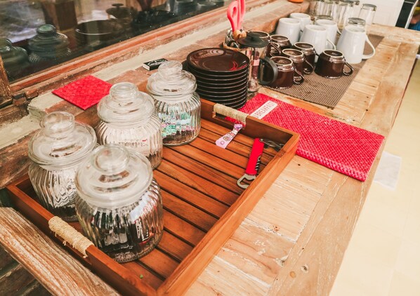 A wooden tray with glass jars and a red placemat labeled "BREAKFAST".
