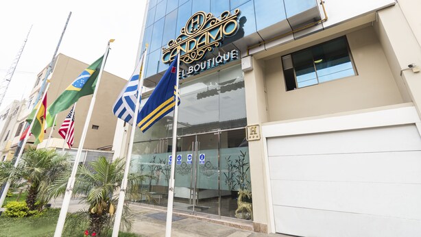 Un edificio moderno con fachada de vidrio y un cartel que dice "CENDAMO EL BOUTIQUE".