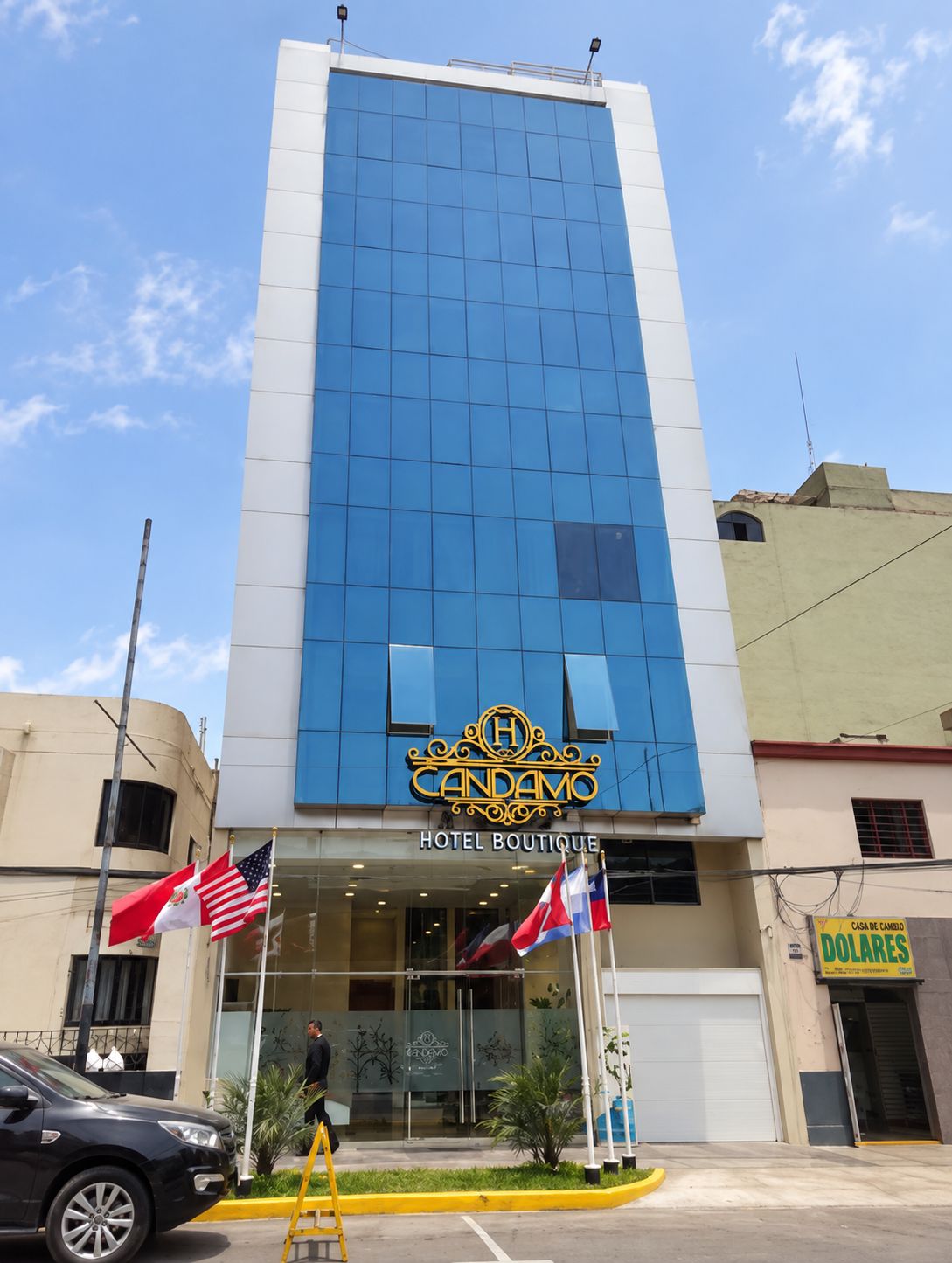 A hotel building with a prominent sign reading 'Hotel Boutique Candamo.'