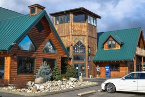 A rustic log cabin-style building with a prominent tower and a sign that reads "Restaurant." - Sumas Mountain Lodge (Sumas)