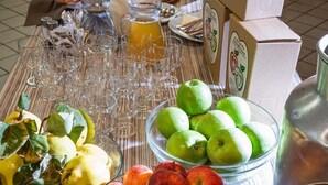 A breakfast buffet with various fruits, beverages, and food items.