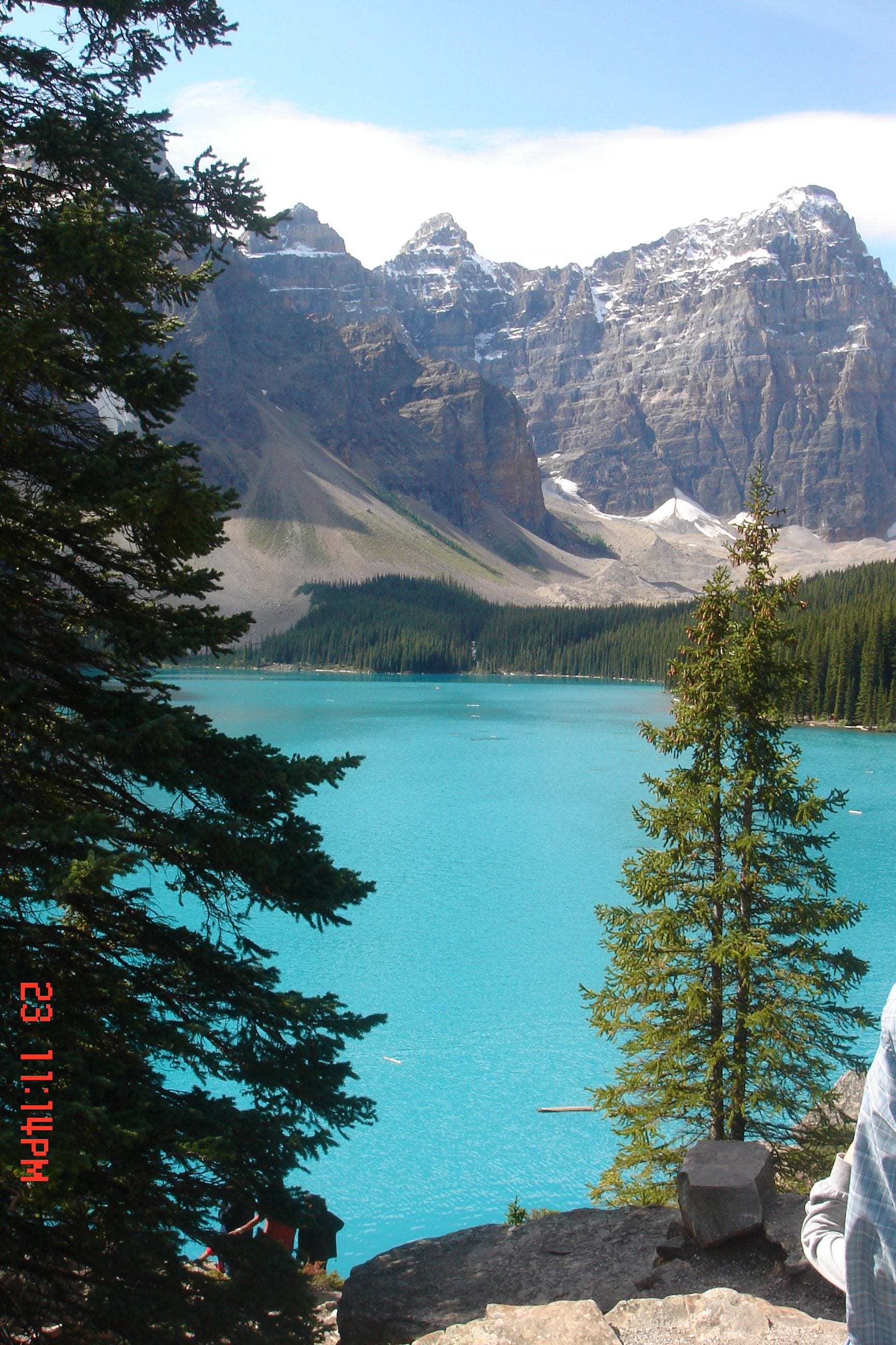 A mountain landscape with a lake and a clear sky.