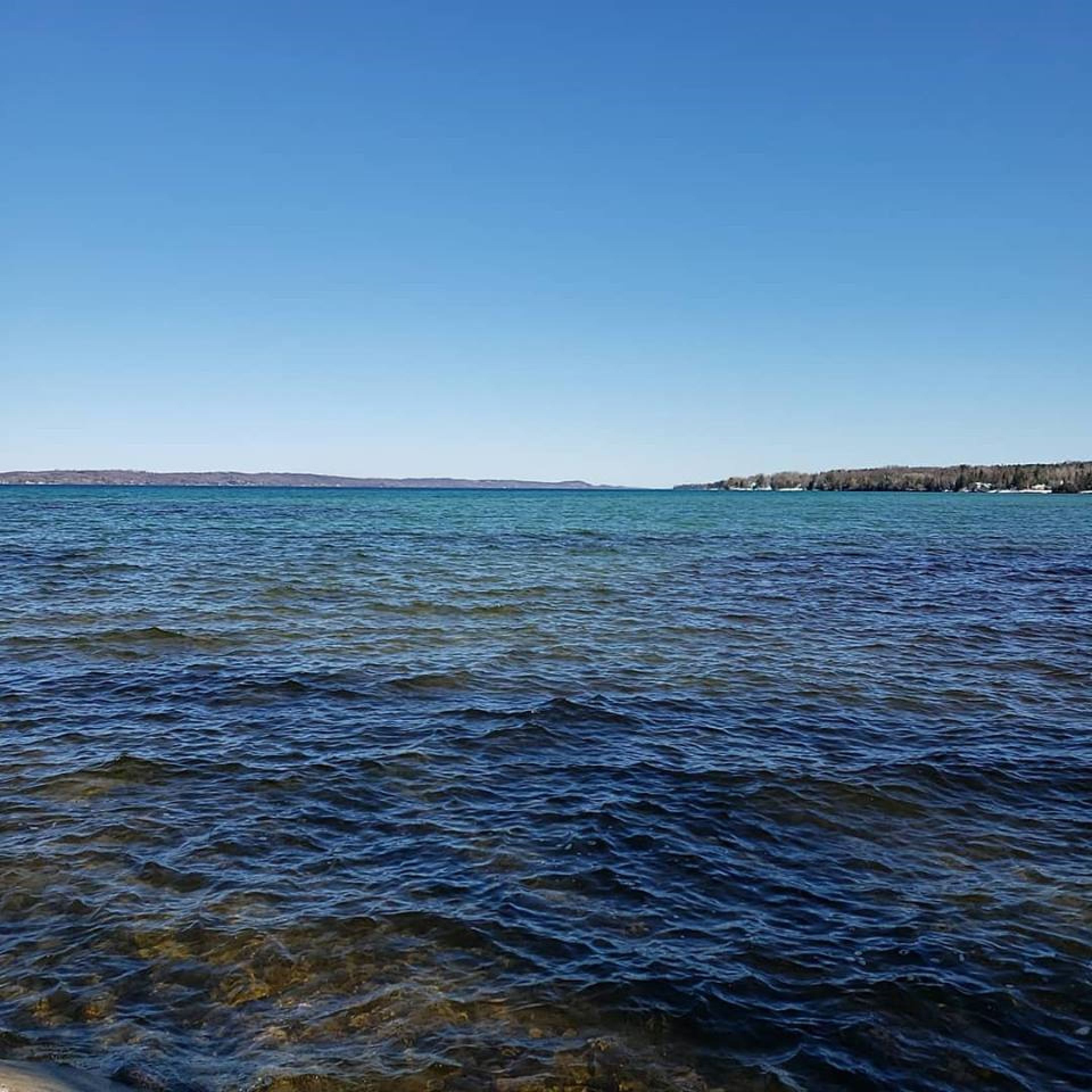 Una masa de agua tranquila bajo un cielo despejado.