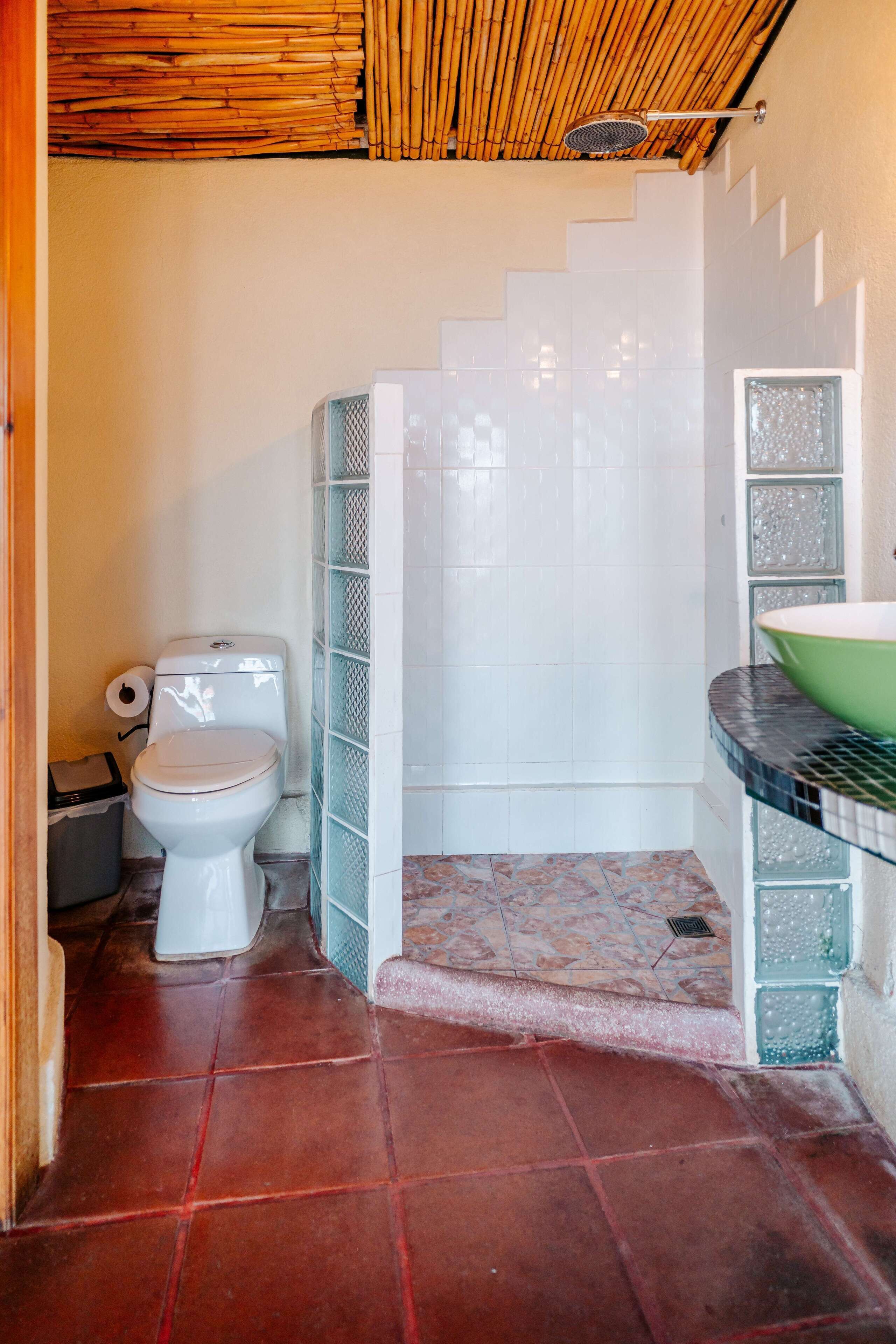Un baño con inodoro, ducha y lavamanos.