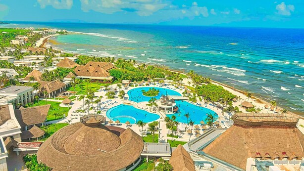 A resort with multiple swimming pools, beachfront, and thatched-roof buildings. - Luxury Home Riviera Maya Bahia Principe 5 Star Resort Pool Jacuzzis Beach Access (Akumal)