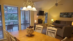 A dining area with a wooden table and chairs, a decorative bowl with pinecones, and a ceiling fan. - 4 Bed/2 bath- sleeps 9, club cards avail, Golf cart, pets ok, neighborhood pool (St Helena Island)
