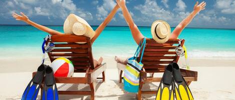 On the beach, sun-loungers, beach umbrellas, beach towels