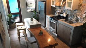 A compact kitchen with a central island, a built-in oven, and a sink.