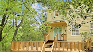 A two-story house with a wooden deck and stairs leading to a porch. - Huge Historic 4BR House w/  Patio, sleeps 12 (Jackson)