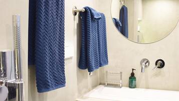 Shower, rainfall showerhead, hair dryer, towels