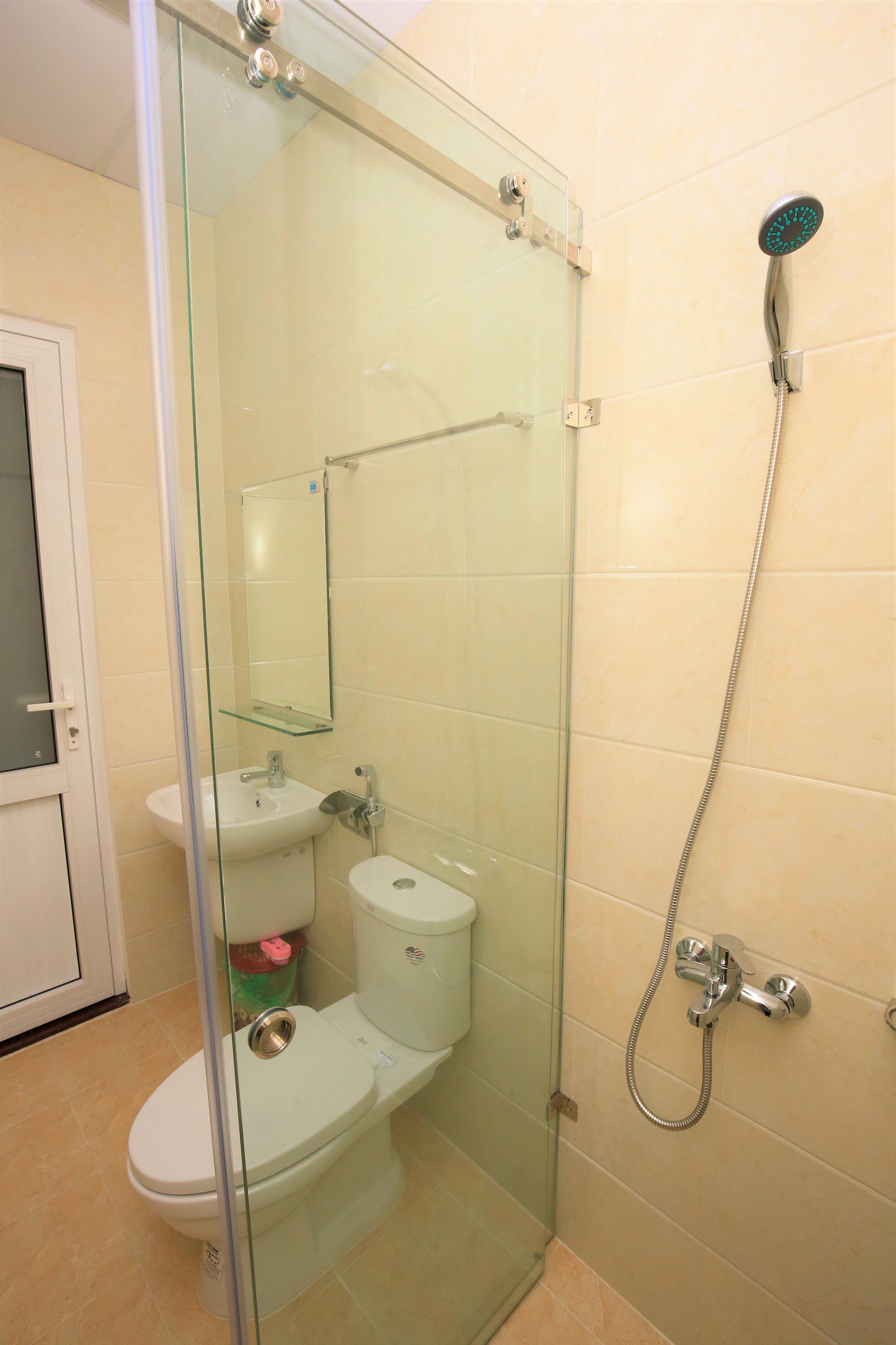 Ein Badezimmer mit Duschkabine, Waschbecken und Toilette.