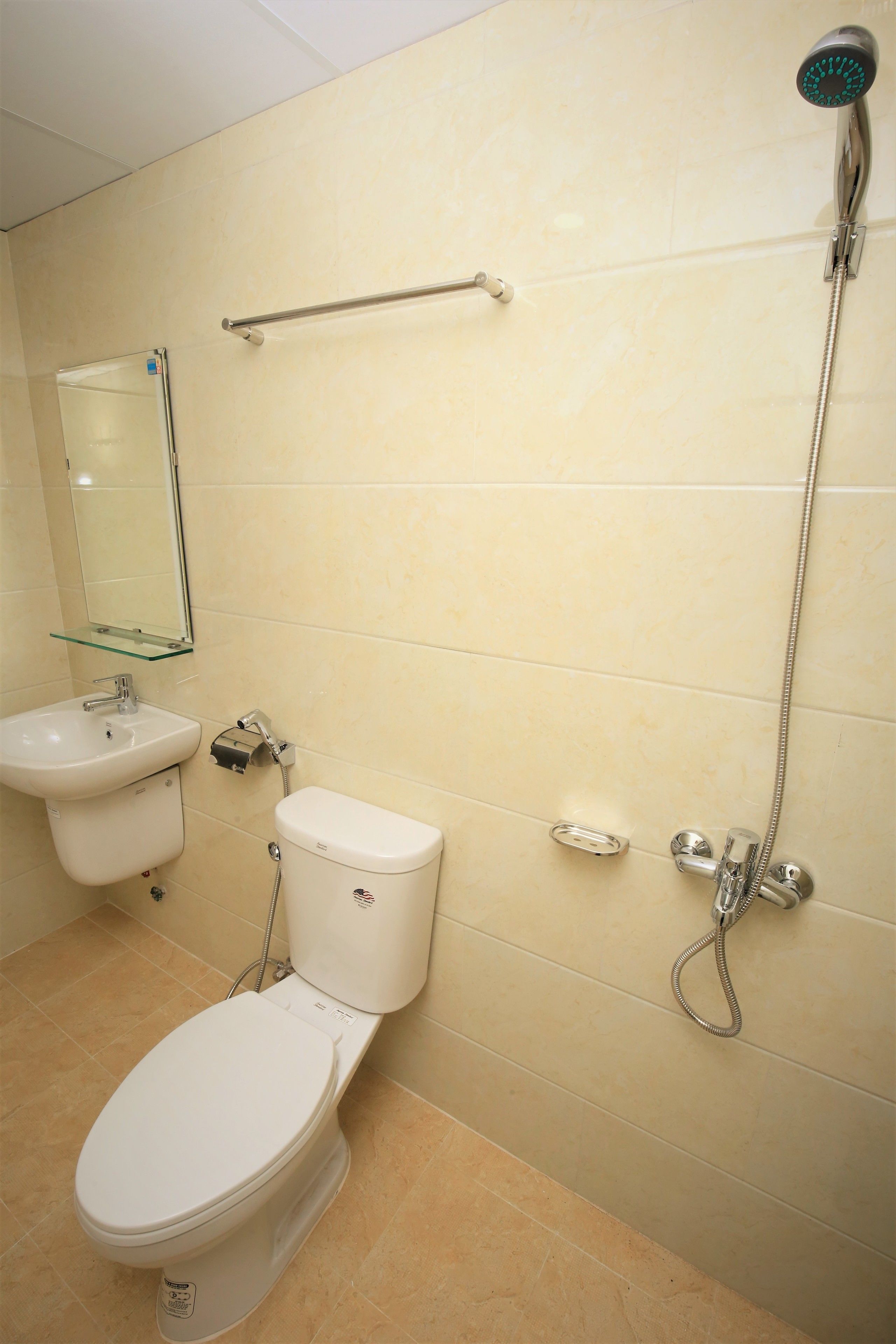 A bathroom with a toilet, sink, and shower.