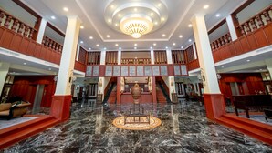 A grand lobby with marble flooring, a central chandelier, and a staircase leading to upper levels. - Hotel de la Renaissance (Siem Reap)