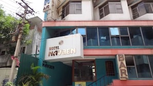 A hotel with a sign reading "HOTEL NAVZEN" and a bar on the ground floor. - Hotel Naveen (Coimbatore)